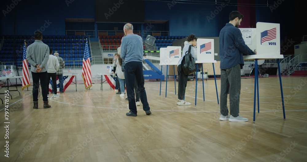 Obraz premium Vote here sign on the floor. Queue of multi ethnic American citizens come to vote in polling station. National Election Day in United States. Political races of US presidential candidates. Civic duty.