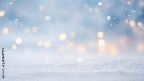 A blurry blue background with snowflakes and a tree © ekalaila