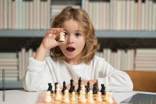 Smart kid playing chess. Clever child thinking about chess.