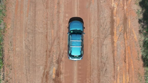 4K, drone 4WD car on red dirt road, rough potholes, close closeup, off road adventure exploration holiday vacation weekend, outback Queensland Australia, wet season