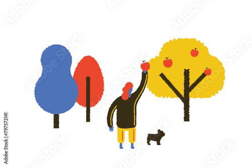 Man walking his dog in the woods and picking apples from a tree