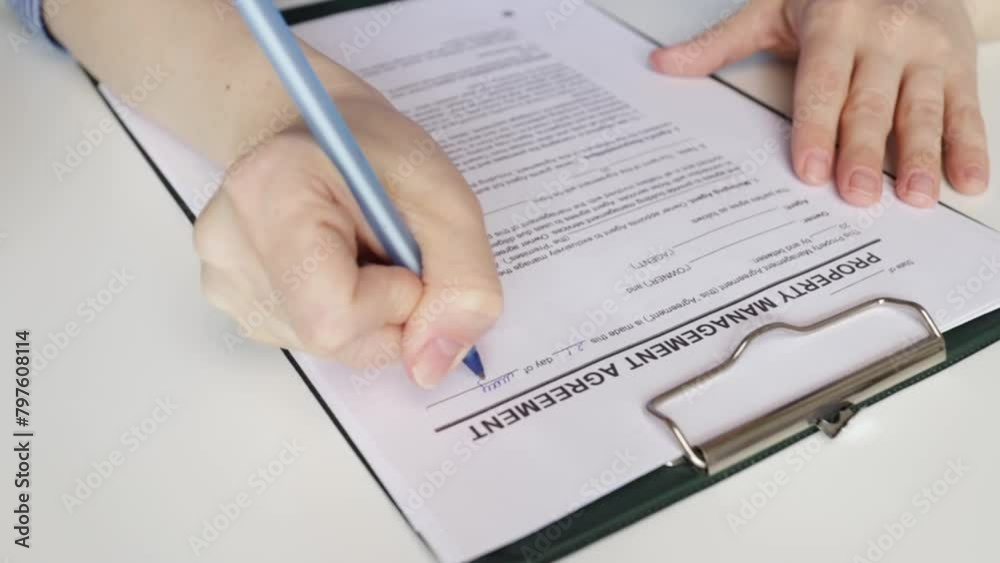 Property management agreement, hand fills out a document, rental deal, landlord, real estate sale, broker Property management agreement, hand fills out a document, rental deal, landlord, real estate sale, broker