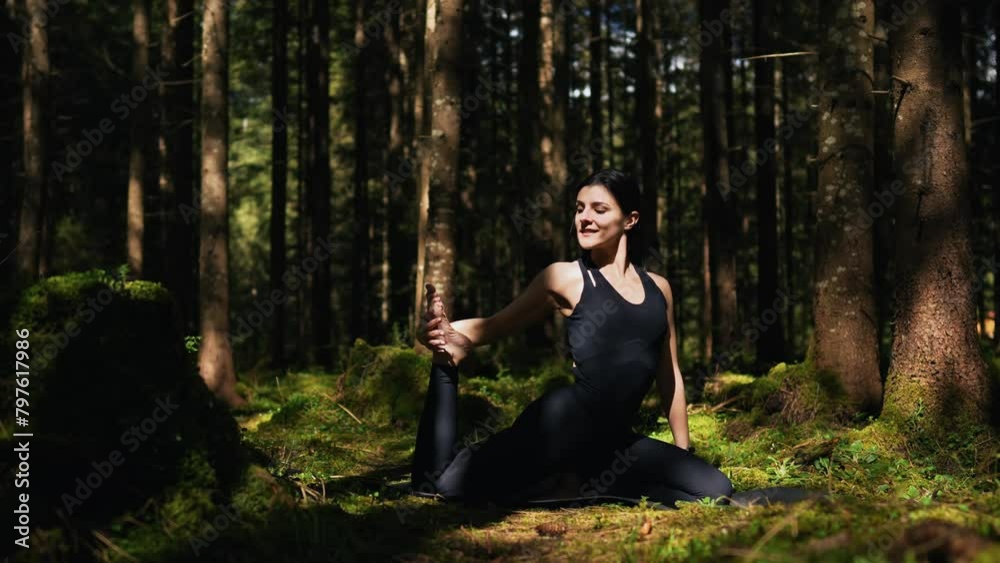 A young woman does yoga and meditates in the forest. Yoga and meditation concept. Yoga asanas. 4K A young woman does yoga and meditates in the forest. Yoga and meditation concept. Yoga asanas. 4K
