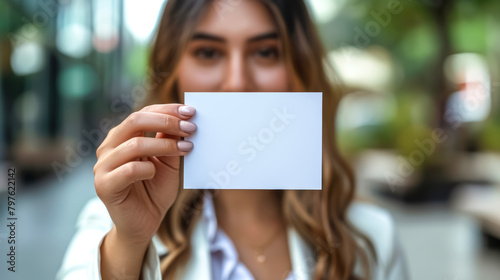 businesswoman holding up a blank business card