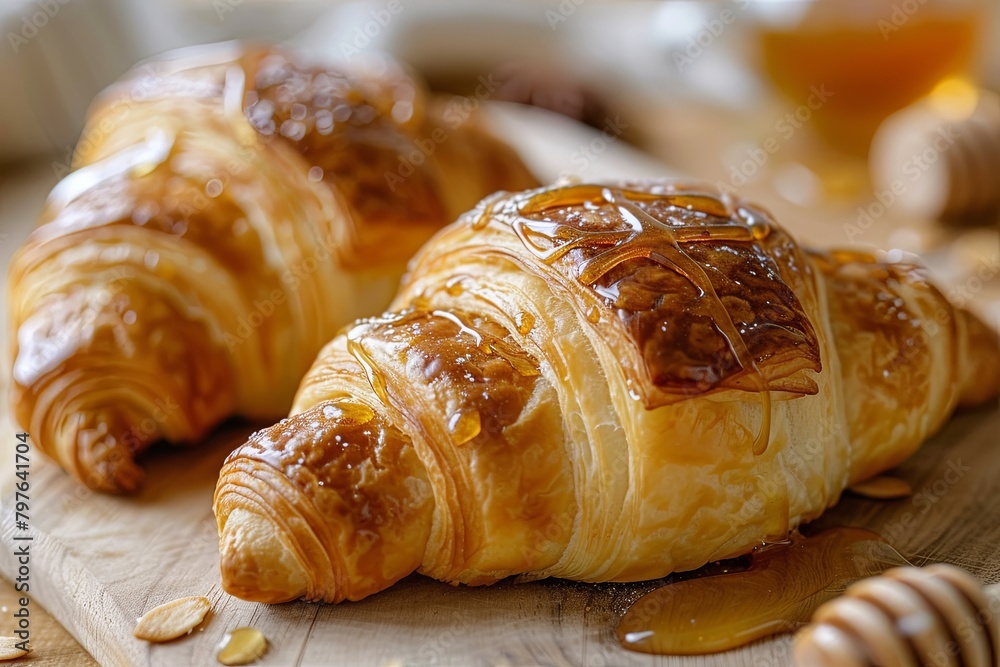 Golden Dough Pastries: Two Honey-Drizzled Croissants in Warm Breakfast Scene