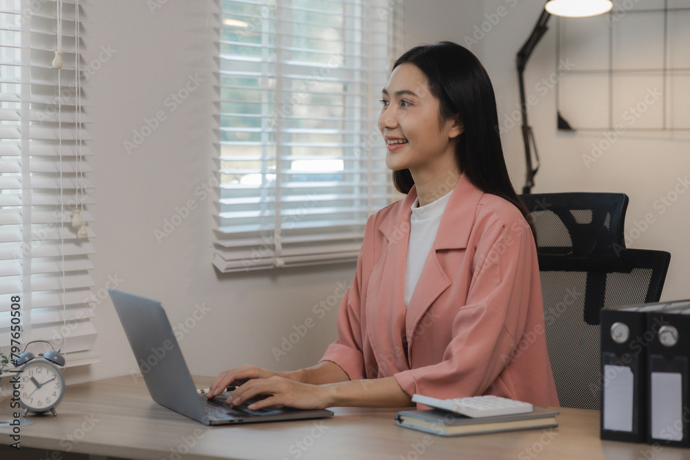 A beautiful Asian woman was happily sitting in her private office in an atmosphere filled with happiness as an assignment was being completed and completed successfully. A beautiful Asian woman was happily sitting in her private office in an atmosphere filled with happiness as an assignment was being completed and completed successfully.