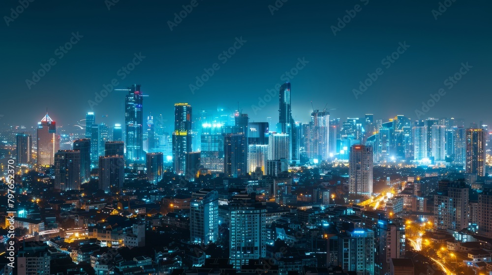 A view of a city skyline at night, featuring numerous towering buildings illuminated by lights