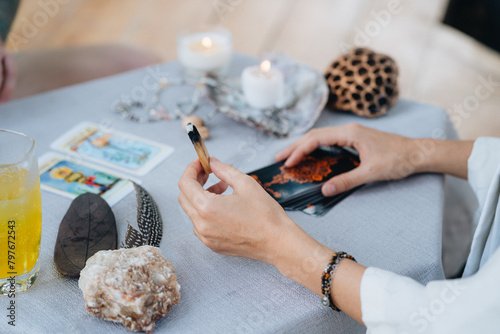 A woman is making tarot layout on the table