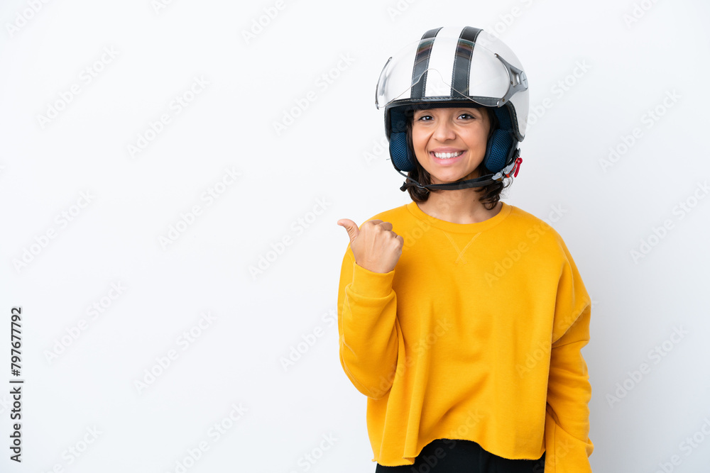 Woman with a motorcycle helmet pointing to the side to present a product Woman with a motorcycle helmet pointing to the side to present a product