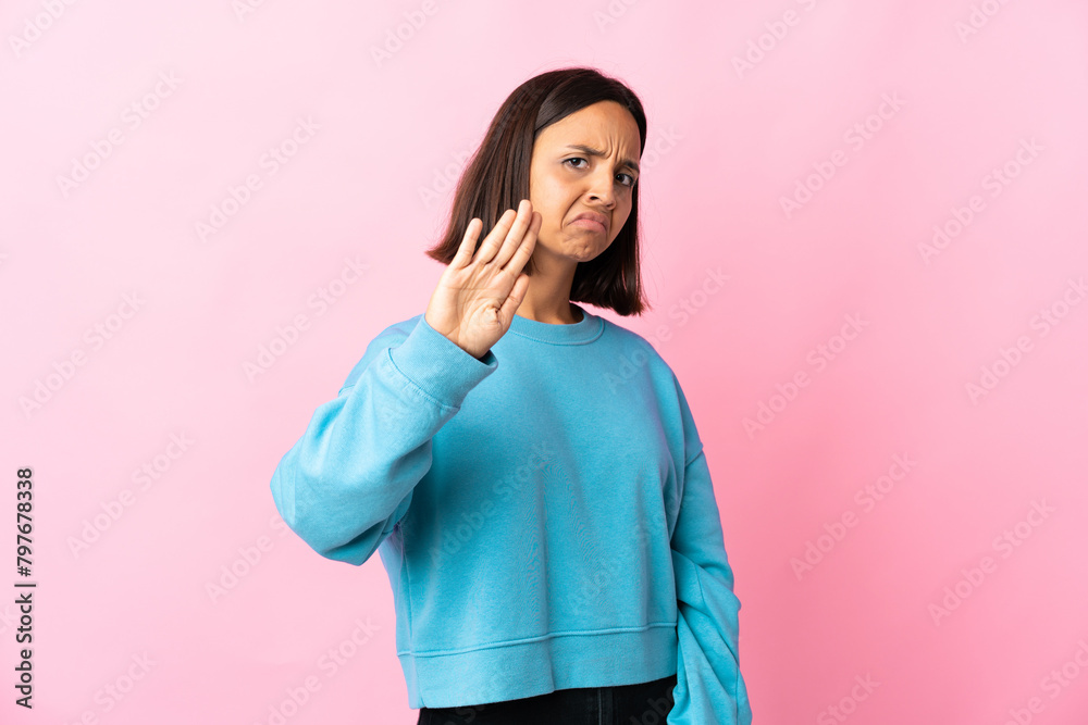 Young latin woman isolated on pink background making stop gesture and disappointed Young latin woman isolated on pink background making stop gesture and disappointed