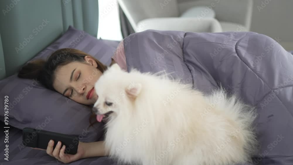 Pretty woman is playing her smart phone after wake up. Pretty woman is playing her smart phone after wake up.