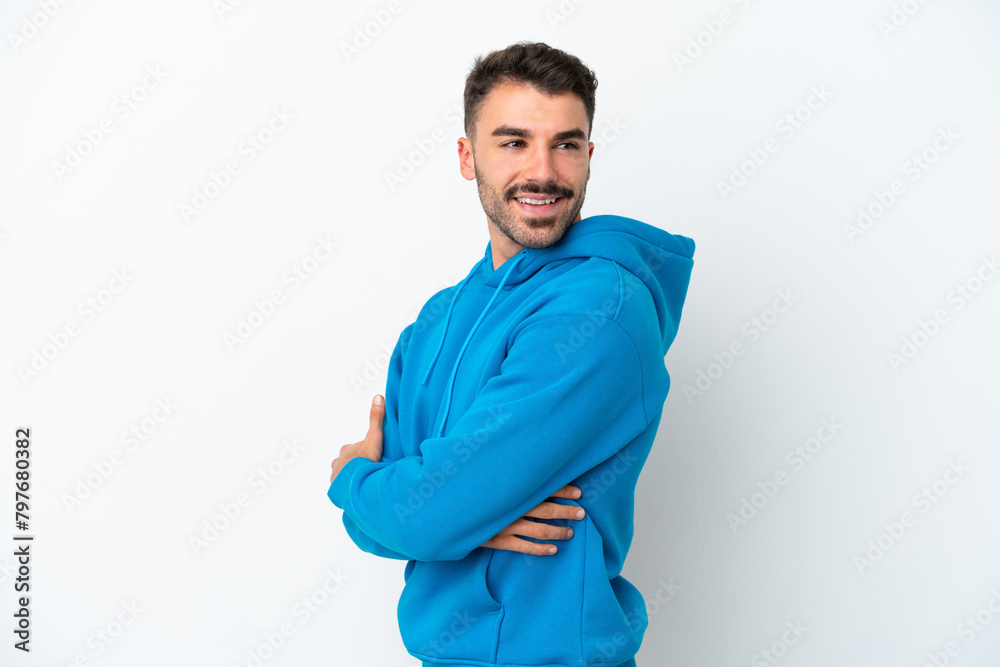 Young caucasian man isolated on white background with arms crossed and happy Young caucasian man isolated on white background with arms crossed and happy