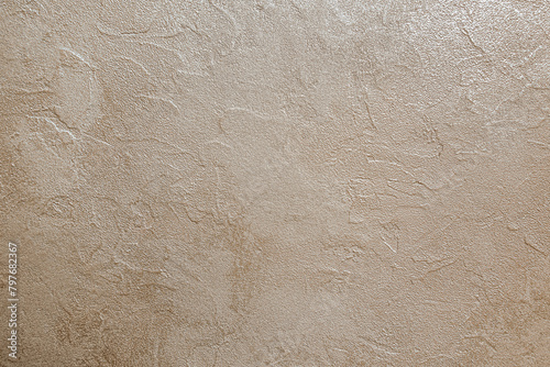 abstract background of white embossed plastered wall painted metallic beige close up
