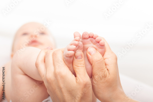 Physiotherapist performing massage on infant's feet