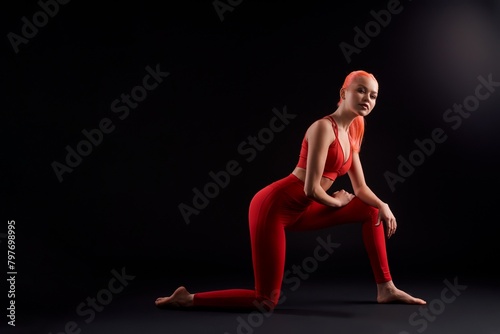 Athlete woman stretching on the floor and looking at the camera