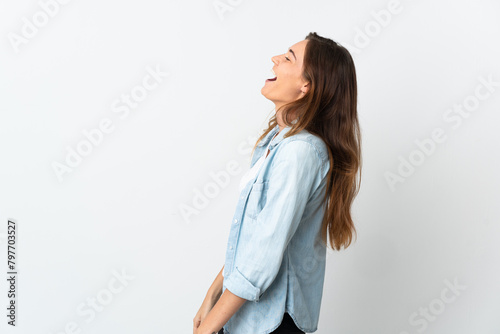 Young Ireland woman isolated on white background laughing in lateral position