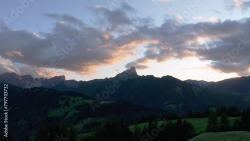 Cinematic sunset aerial orbit view of the Sass de Putia in cloud-kissed Dolomites. The drone is slowly rotating to the left having the mountain peak in the middle of the frame. LuPa Creative.