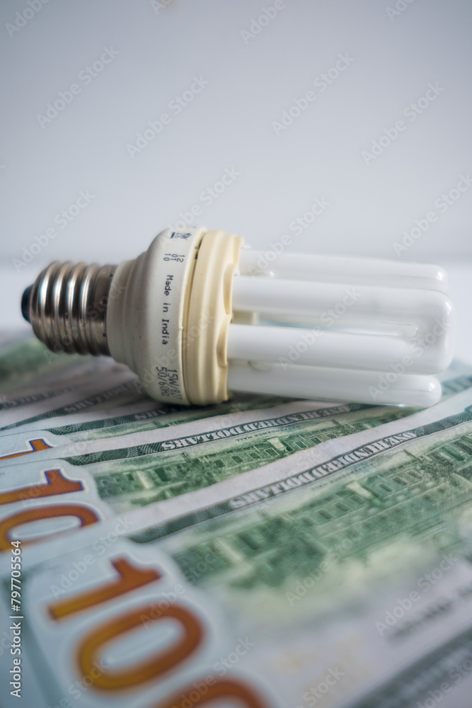 Light bulb with 100 usd note bills , Increase in electricity tariffs Light bulb with 100 usd note bills , Increase in electricity tariffs