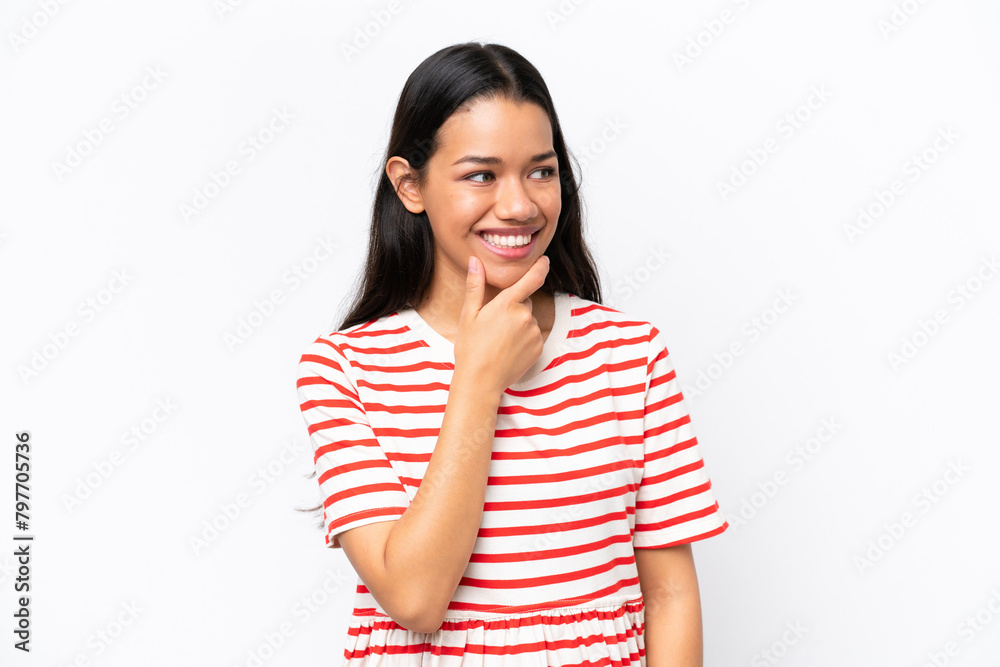 Young Colombian woman isolated on white background looking to the side and smiling Young Colombian woman isolated on white background looking to the side and smiling