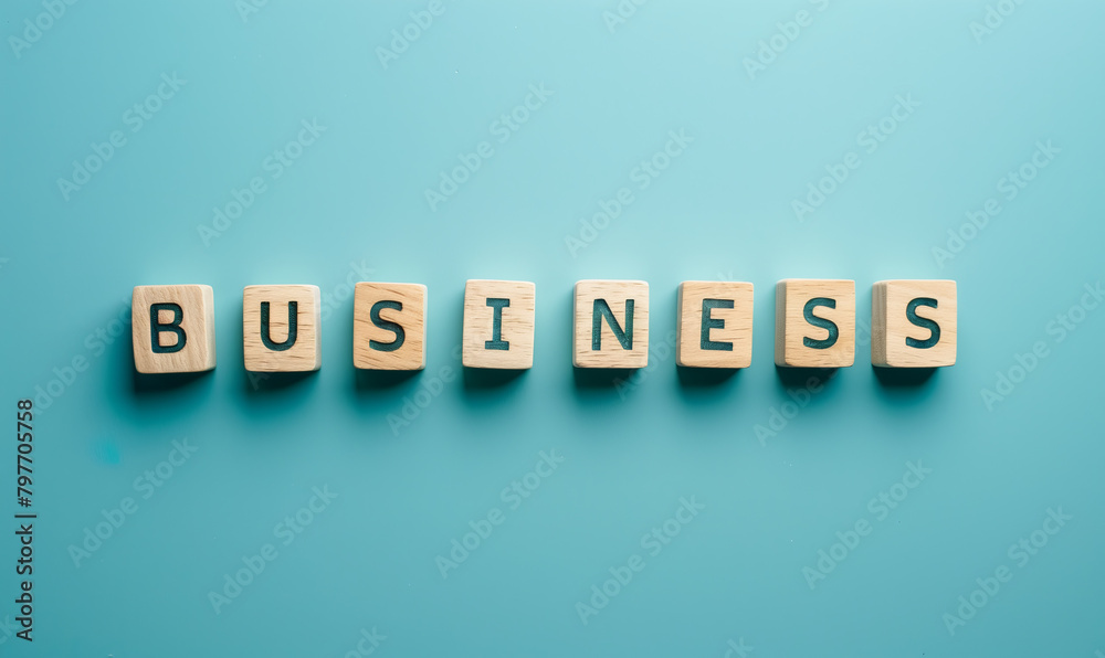 Wooden cubes blocks row forming business title text inscription pointing to topic of motivation and work success, blue background. Wooden cubes blocks row forming business title text inscription pointing to topic of motivation and work success, blue background.
