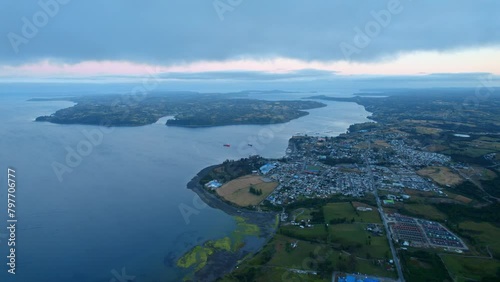 Aerial view of the Lemuy island with Chonchi in the background, during blue hour photo