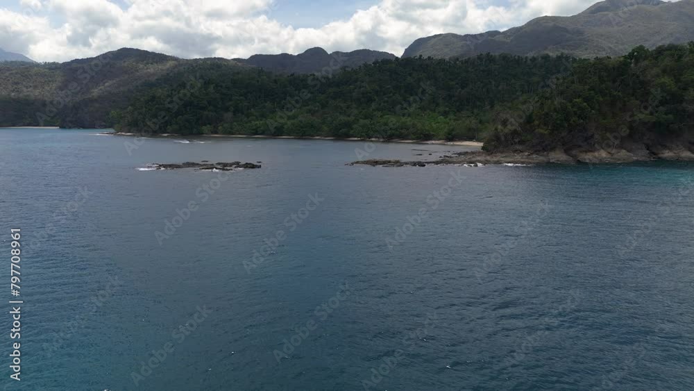 Sideways movement around a headland in the Philippines with boulders in the water. Sideways movement around a headland in the Philippines with boulders in the water.