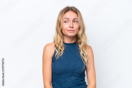 Young Russian woman isolated on white background having doubts while looking side © luismolinero
