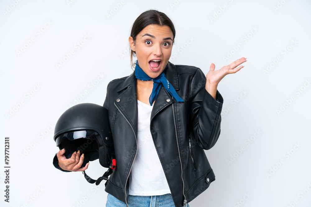 Young caucasian woman with a motorcycle helmet isolated on blue background with shocked facial expression Young caucasian woman with a motorcycle helmet isolated on blue background with shocked facial expression
