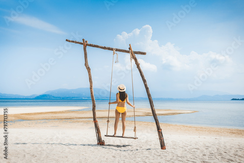 Traveler asian woman relax and travel in swing on summer beach at Koh Rap Samui in Surat Thani Thailand © Peera