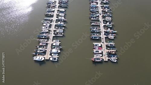 Drone view of Cais do Bico boat deck, serene water in Murtosa, Aveiro, Portugal