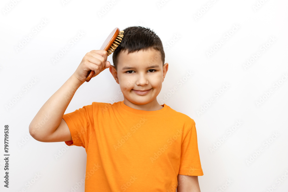 A guy combs his hair with a comb. Sincere children's emotions. A guy combs his hair with a comb. Sincere children's emotions.
