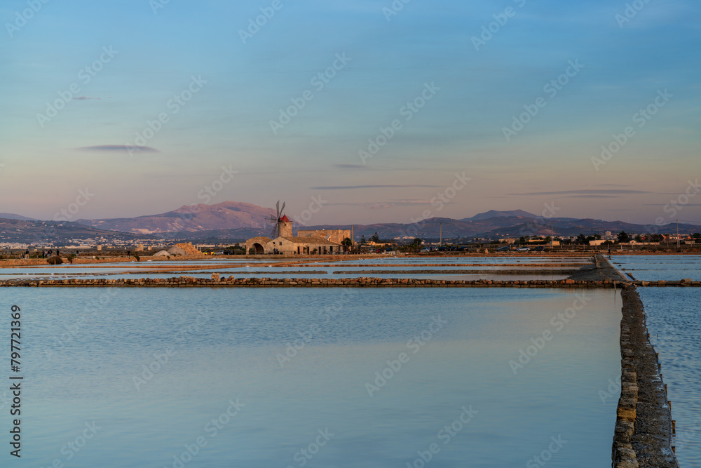 view of the windmill and salt flat museum of Paceco at sunset
