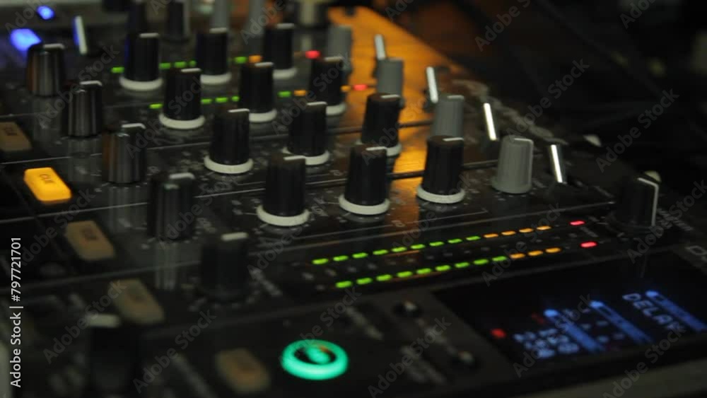 handheld shot of a dj mixer handheld shot of a dj mixer