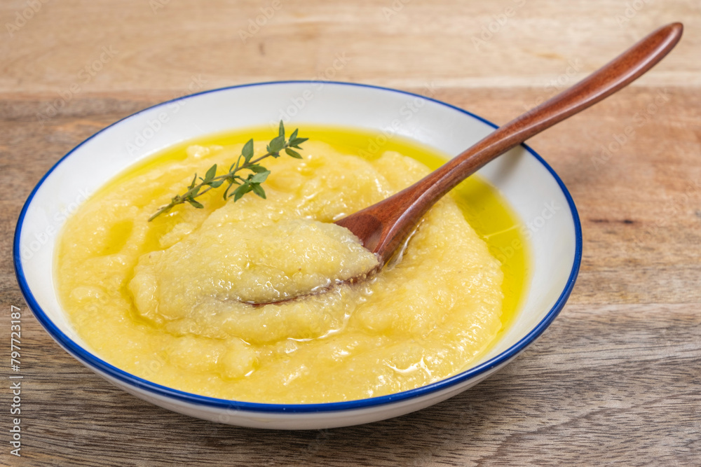 Polenta or grits or mamaliga in ceramic bowl. Polenta or grits or mamaliga in ceramic bowl.