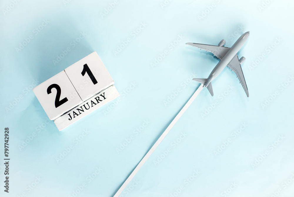 January calendar with number 21. Top view of a calendar with a flying passenger plane. Planner for the year by date of the day. Copy space. January calendar with number 21. Top view of a calendar with a flying passenger plane. Planner for the year by date of the day. Copy space.