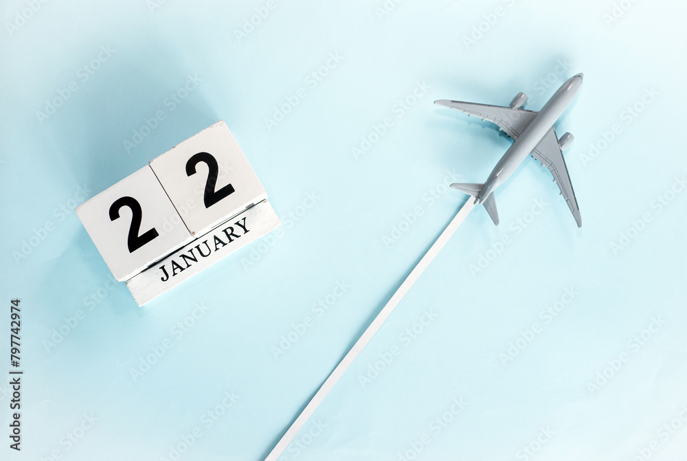 January calendar with number 22. Top view of a calendar with a flying passenger plane. Planner for the year by date of the day. Copy space. January calendar with number 22. Top view of a calendar with a flying passenger plane. Planner for the year by date of the day. Copy space.