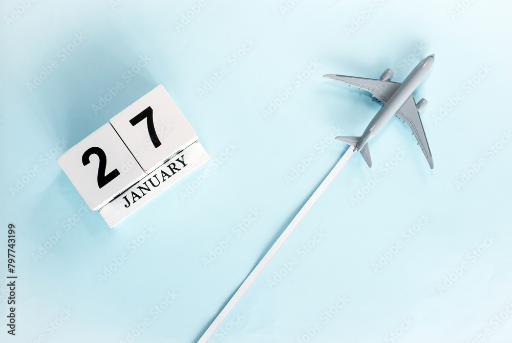January calendar with number 27. Top view of a calendar with a flying passenger plane. Planner for the year by date of the day. Copy space. January calendar with number 27. Top view of a calendar with a flying passenger plane. Planner for the year by date of the day. Copy space.