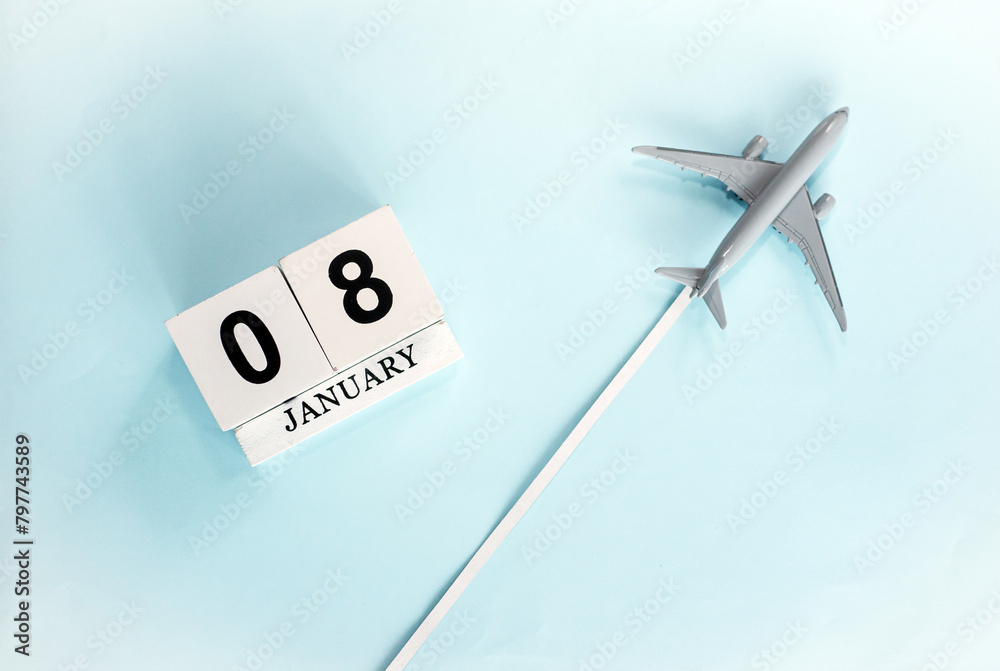 January calendar with number 8. Top view of a calendar with a flying passenger plane. Planner for the year by date of the day. Copy space. January calendar with number 8. Top view of a calendar with a flying passenger plane. Planner for the year by date of the day. Copy space.