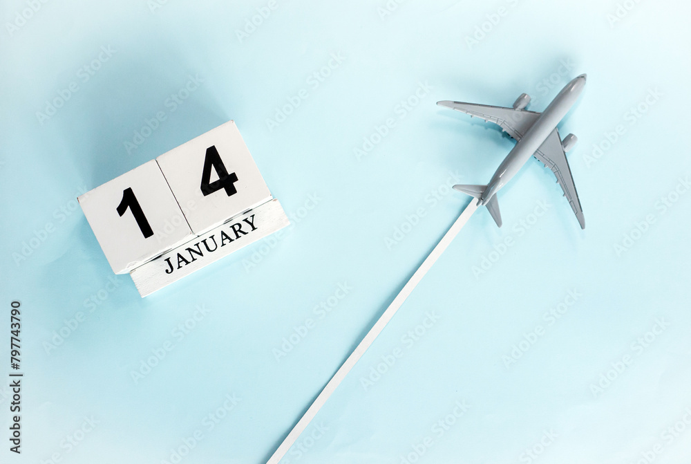 January calendar with number 14. Top view of a calendar with a flying passenger plane. Planner for the year by date of the day. Copy space. January calendar with number 14. Top view of a calendar with a flying passenger plane. Planner for the year by date of the day. Copy space.