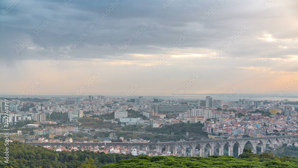 Panoramic overview during sunrise over Lisbon and Almada from a viewpoint in Monsanto morning timelapse.