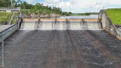 4K, dam water overflow wall, drone approach floodgate wall photo