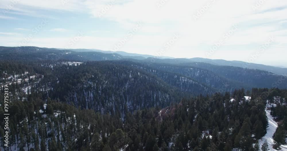 Aerial view flying over a snow covered mountain in the New Mexico Rocky Mountains Aerial view flying over a snow covered mountain in the New Mexico Rocky Mountains