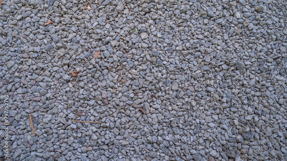 Granite gravel stone rocks flooring pattern surface texture. Close-up of exterior material for design decoration background. Rubble