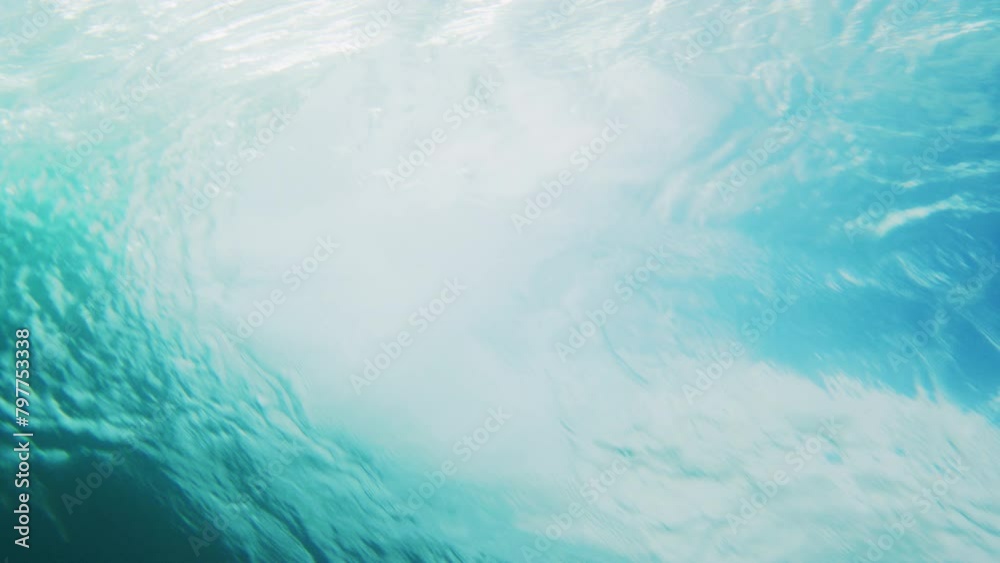 Rearview of large barrel rising and crashing into vortex, underwater