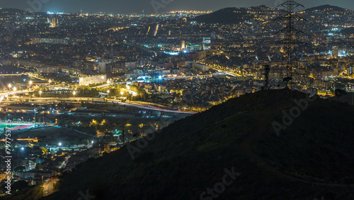 Barcelona and Badalona skyline with roofs of houses and sea on the horizon night timelapse