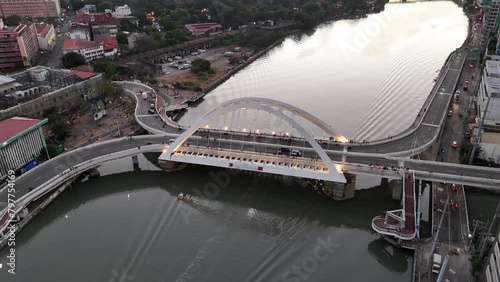 Drone shot of the Binondo Intramuros Bridge spans the Pasig River at sunset in Manila, Philippines