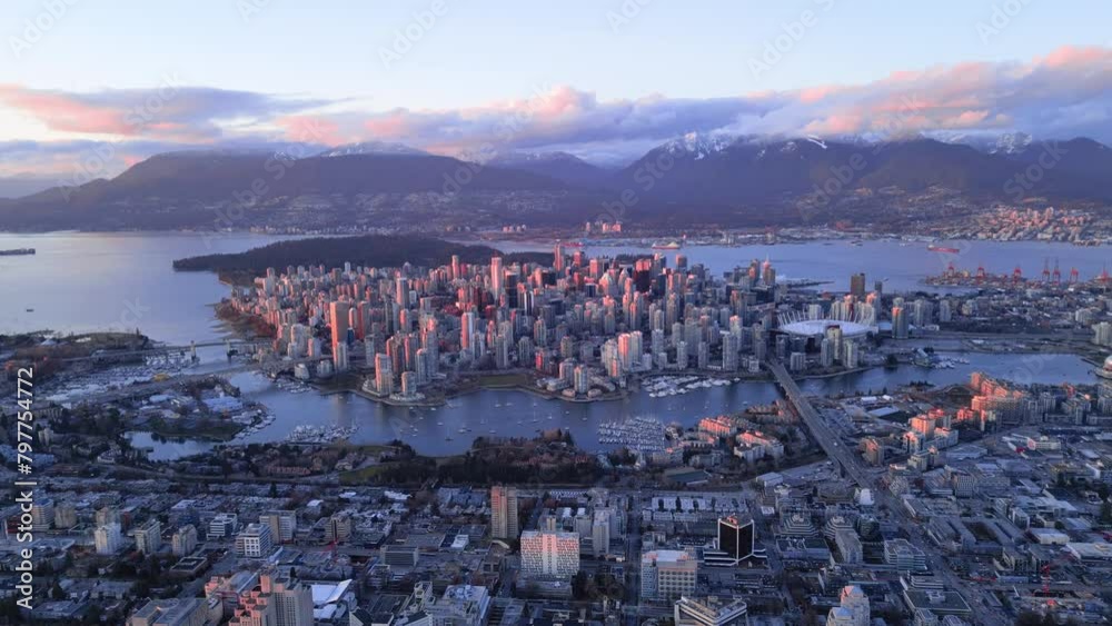 Aerial footage of the urban cityscape of Vancouver at sunset with in ...