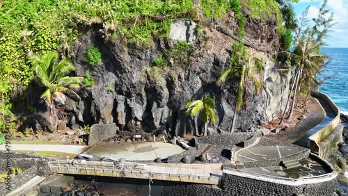 Drone footage of the Arahoho Blowhole on the Pacific Ocean Coast in Hitiaa O Te Ra, French Polynesia photo