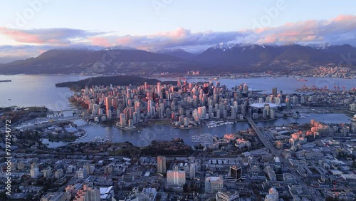 Aerial footage of the urban cityscape of Vancouver at sunset with in British Columbia, Canada