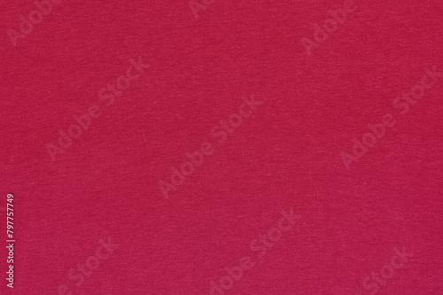 Closeup of magenta cotton jersey plain fabric with stitches texture